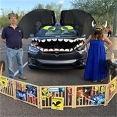 couple standing by a decorated car
