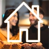 woman and man with hands out holding a glowing house outline