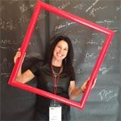 photo of Mimi Damrauer holding a red frame around her face