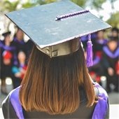 back of a girl's head that is wearing a cap and gown