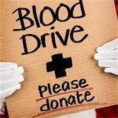 gloved hands holding a cardboard sign that says "blood drive, please donate"