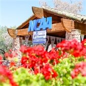 entrance to Grayhawk Golf Club with NCAA sign and flowers