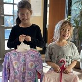 two girls holding pajamas