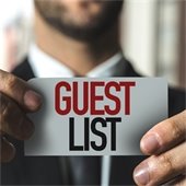 man holding a guest list sign