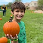 boy holding small pumpkin