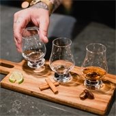 hand with three samples of tequila