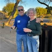 man and woman with drinks in a garden