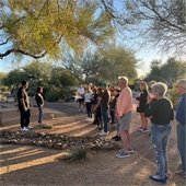 residents listening to someone speak in a garden