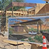 guardhouse banner along construction fencing