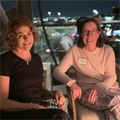 two ladies sitting at a happy hour