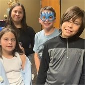 four kids standing at the Hanukkah Party