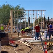 Men working on putting up frame pieces at the Talon gate