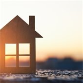 cutout of a house in front of sunset