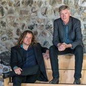 performers from a band sitting on a bench