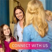 women and kids meeting at a door