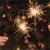sparklers in front of a Christmas Tree