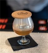 cocktail with Cook and Craft coaster on top of it