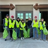 volunteers in vests ready to pick up trash