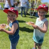 two boys with spiderman hats and spider tattoos at Easter event