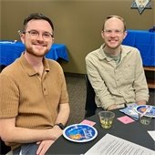 two men sitting at a table 