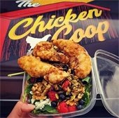 salad with chicken and the chicken coop logo in the background