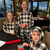 three siblings in matching pajamas