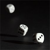 three dice rolling on black background