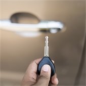 man holding key near his car