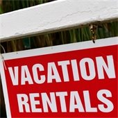 small wood house with red tag that says "rent"